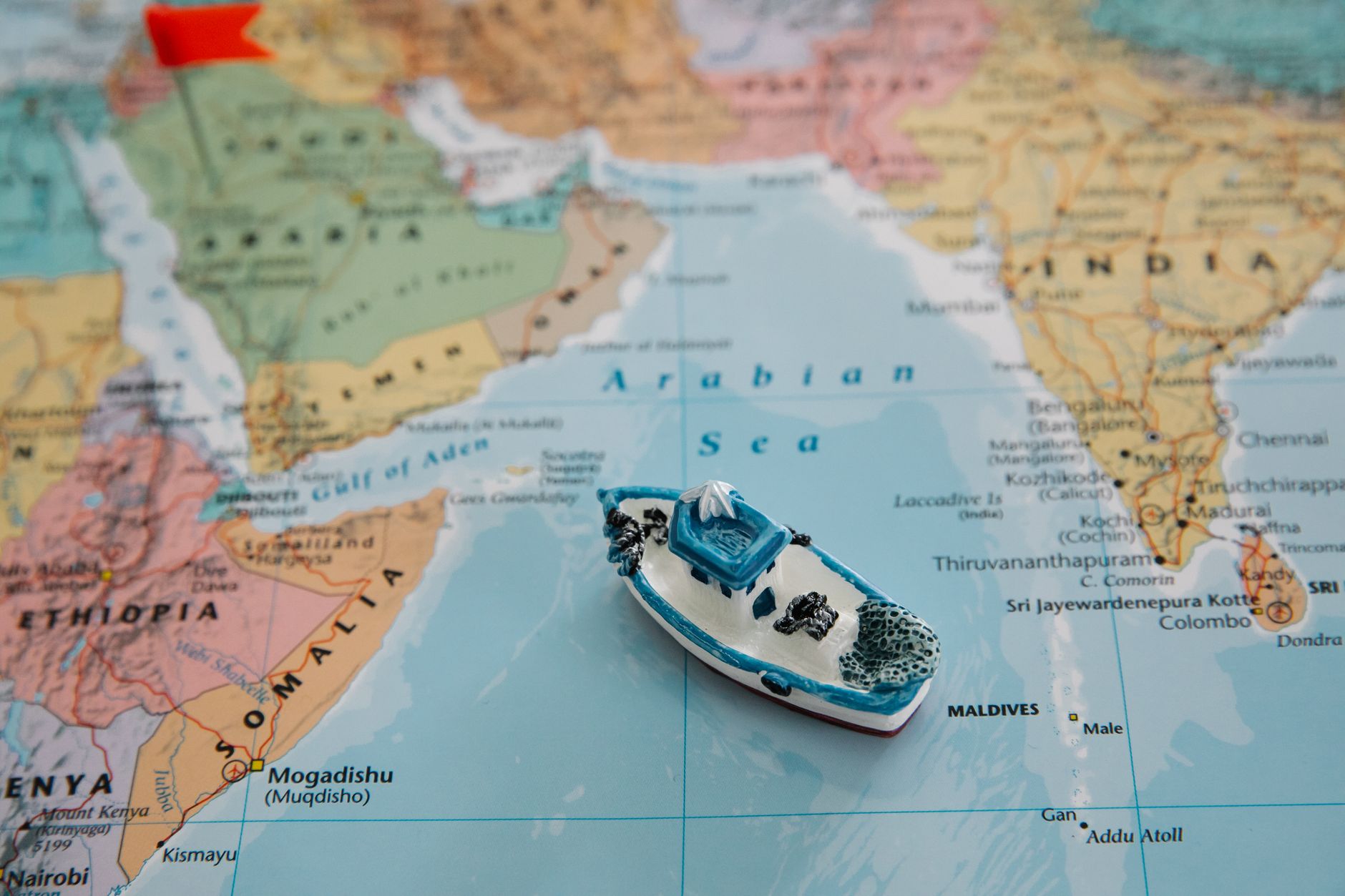 Model cargo ship on a world map